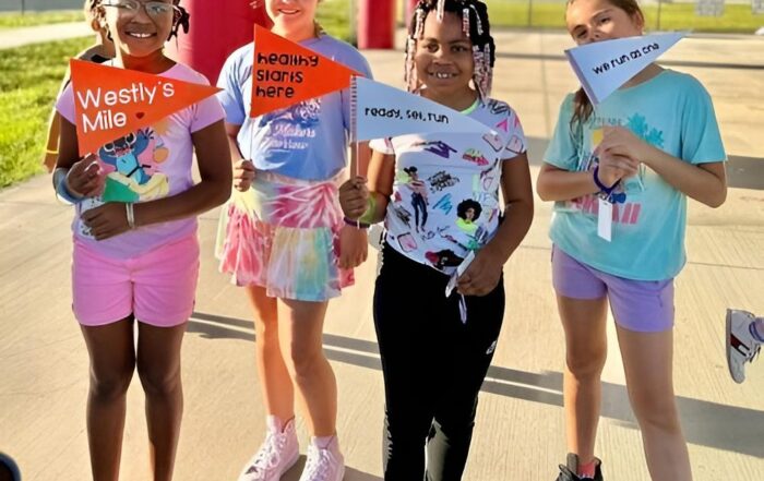Children holding Westly's Mile Banners