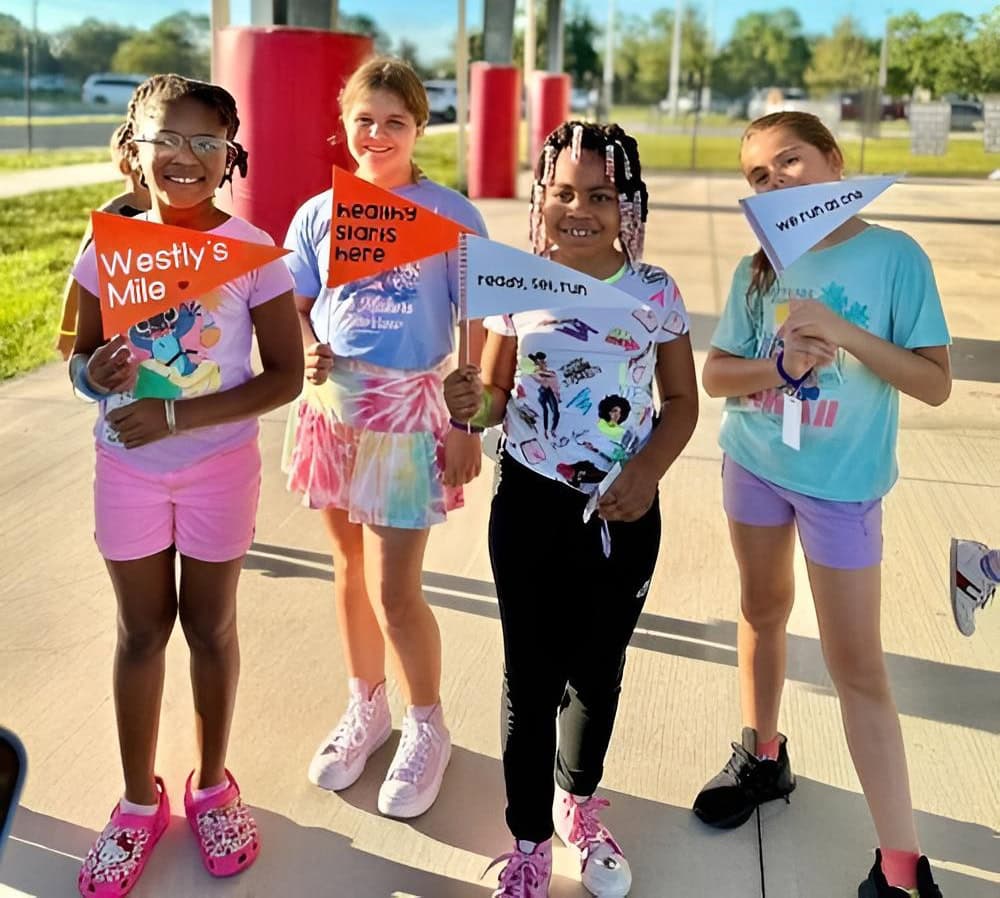 Children holding Westly's Mile Banners