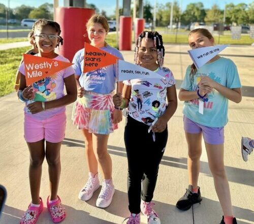 Children holding Westly's Mile Banners